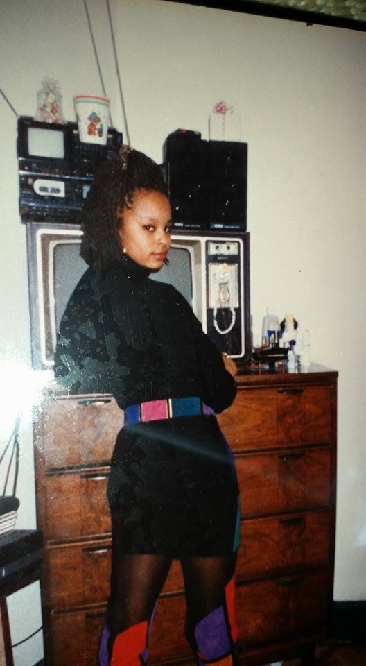 Sonya in a black outfit, looking back over her shoulder