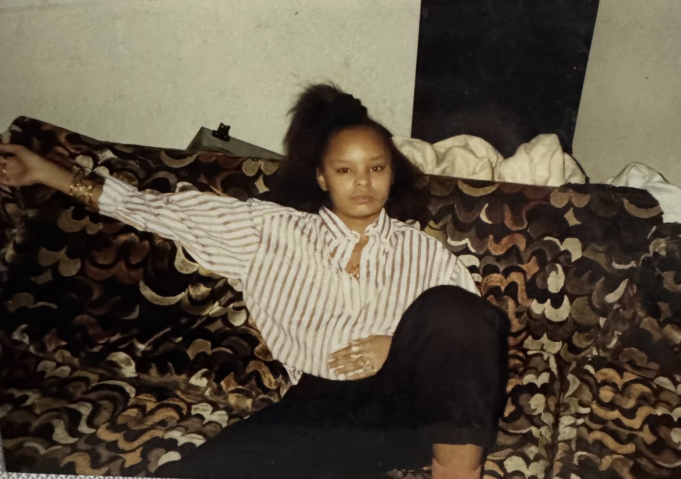 Sonya relaxing on a patterned couch